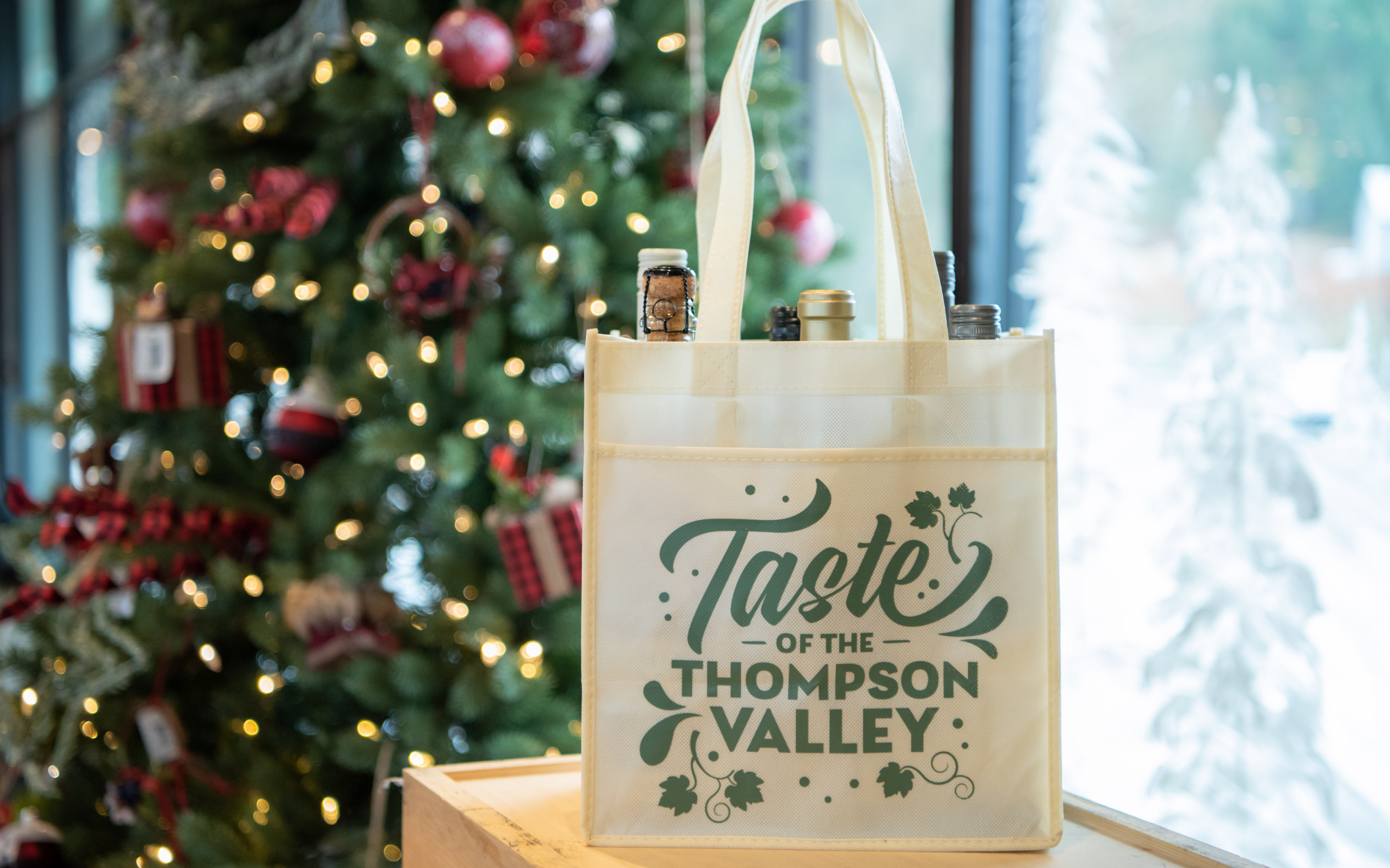 A Taste of the Thompson Valley Wine 6-Pack sitting on a counter in front of a christmas tree.